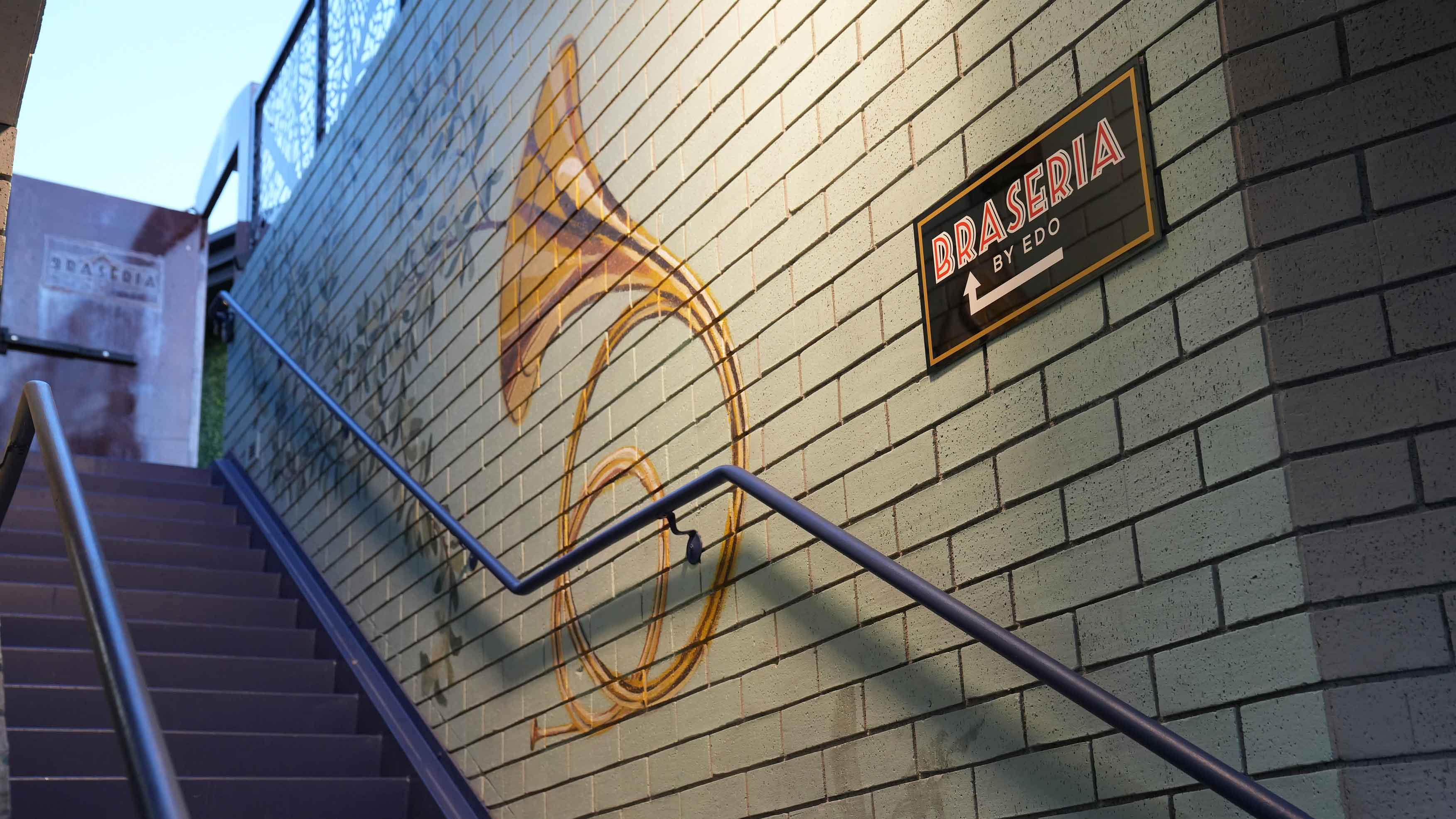 The exterior stairs and Braseria by EDO entrance sign