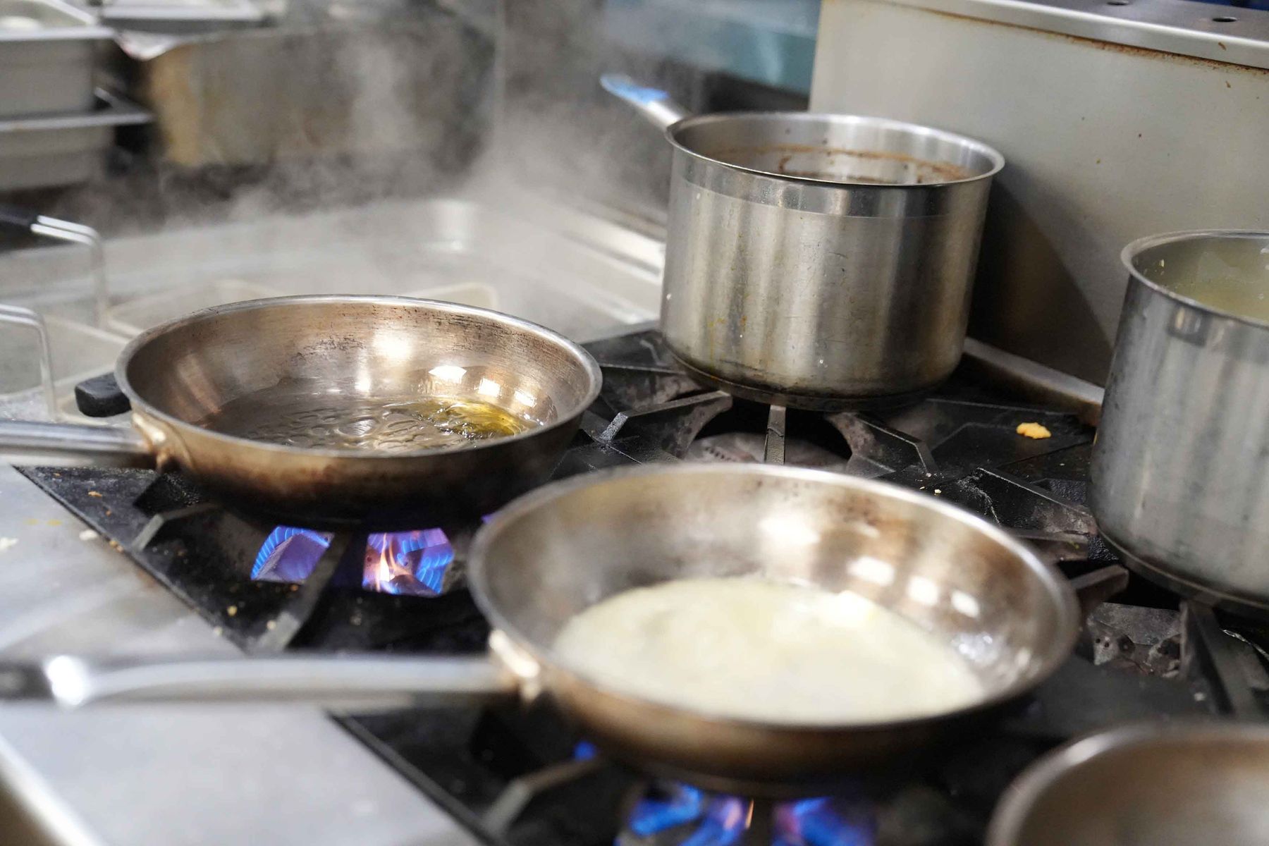 Pans on the burners in the Braseria kitchen before service
